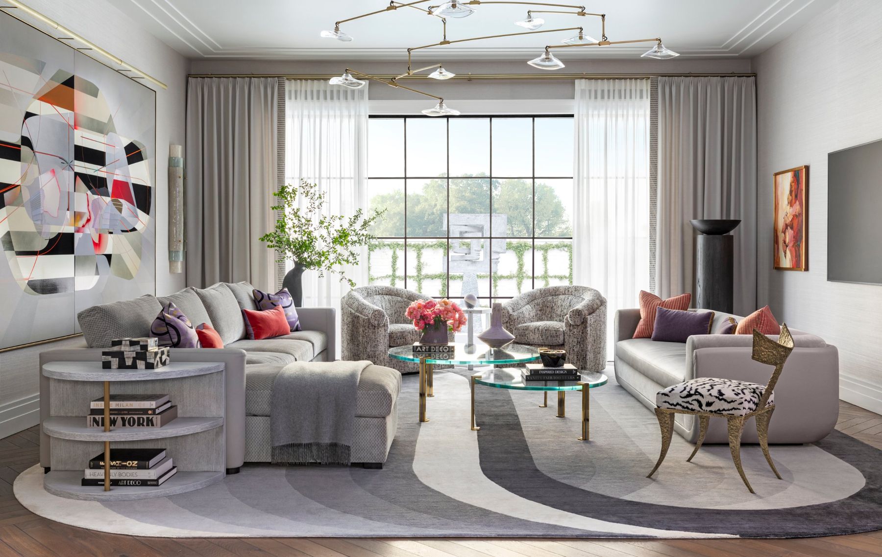 Gray living room with a brass mobile chandelier, sheer drapery and a large steel window onto the terrace