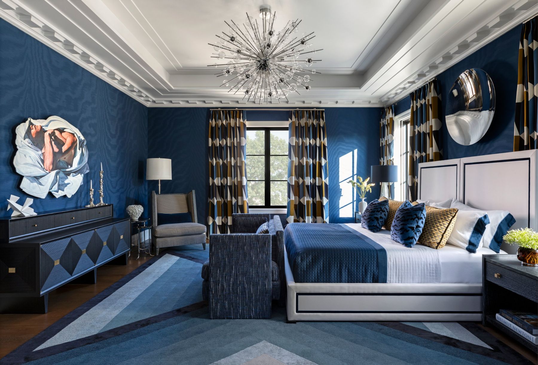 Blue moire primary bedroom with a sputnik chandelier, geometric drapery and a coffered white ceiling