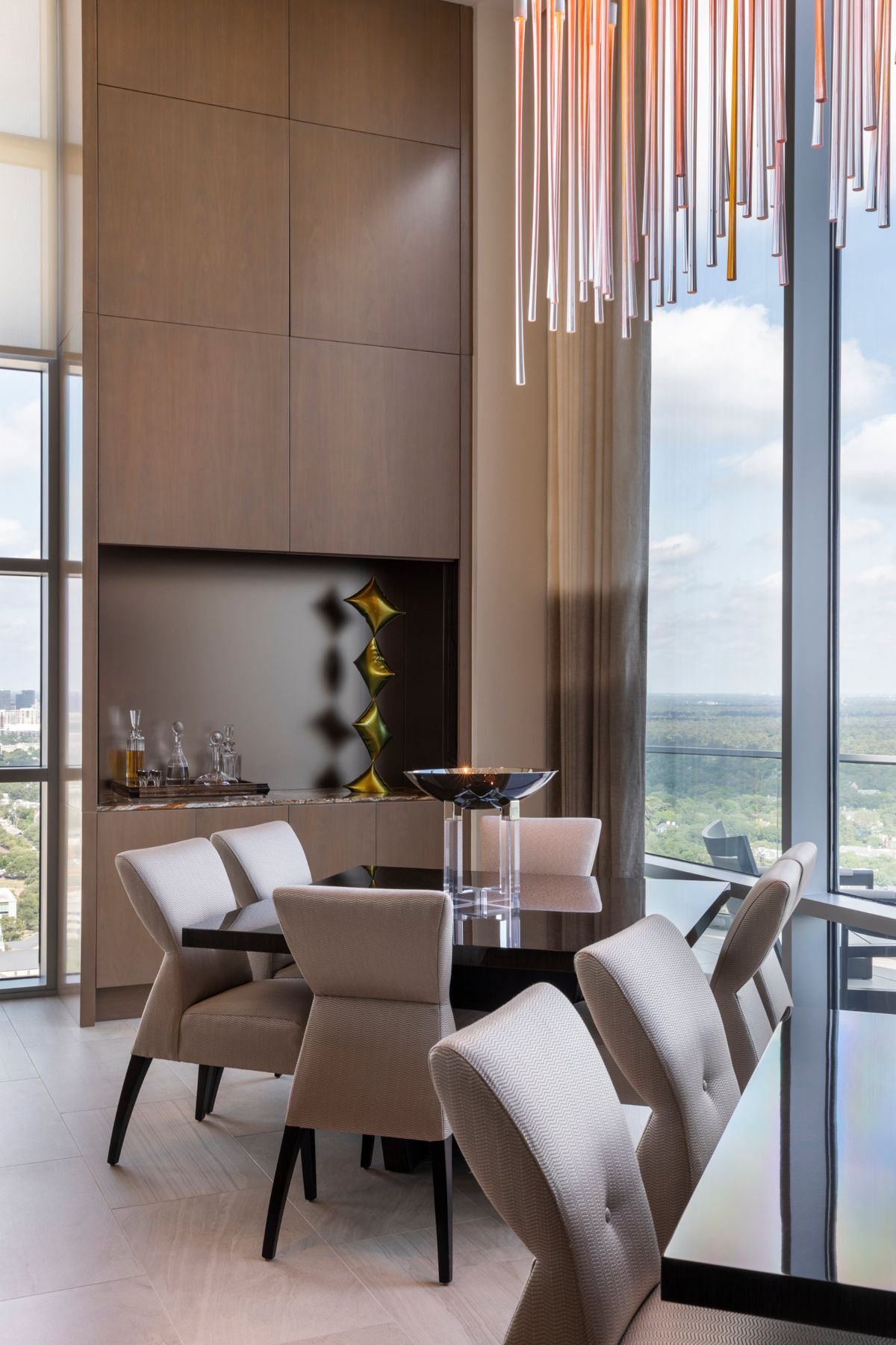 Bar niche open, with decanters and a gold sculpture on the counter