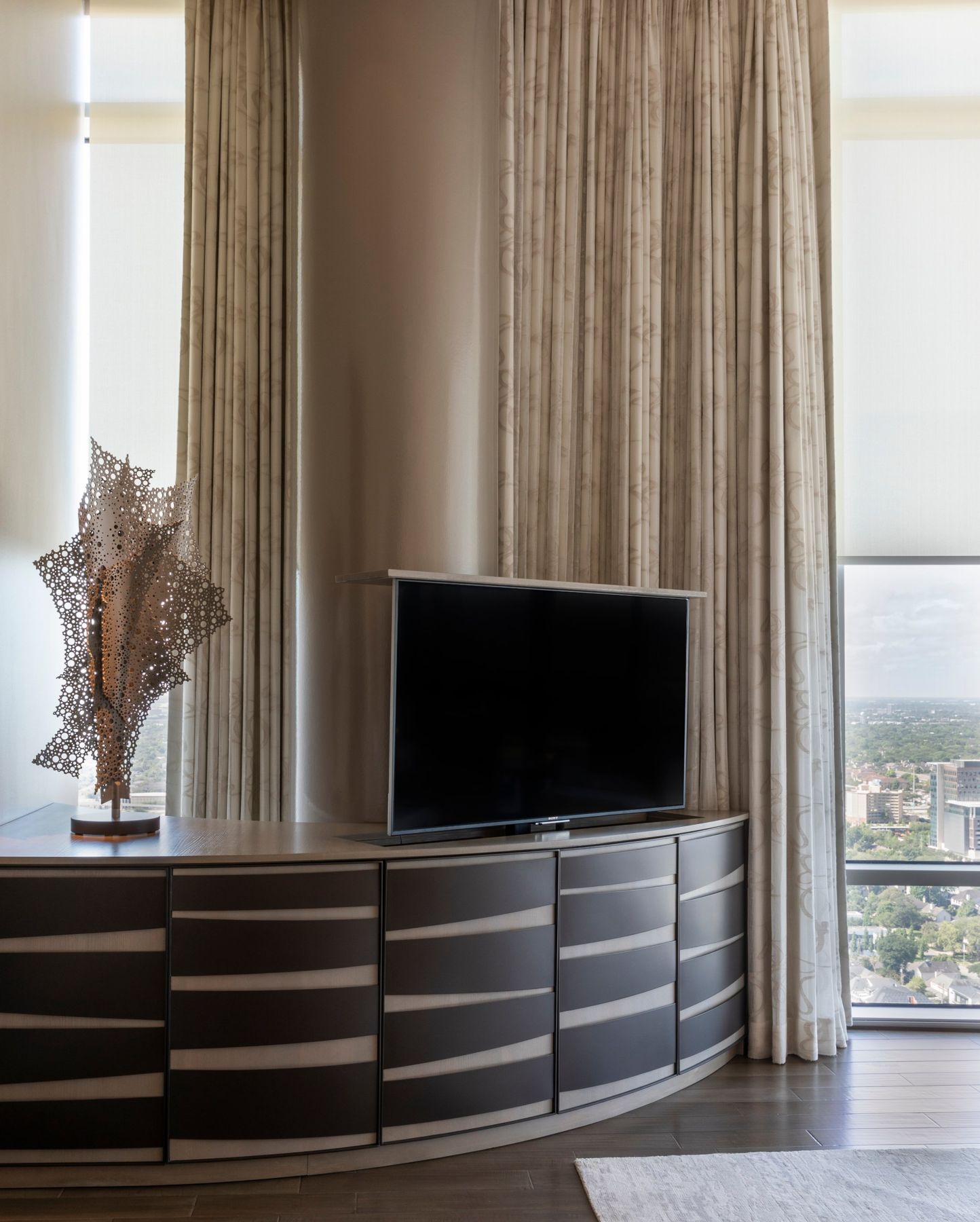 TV raised out of a curved bedroom cabinet